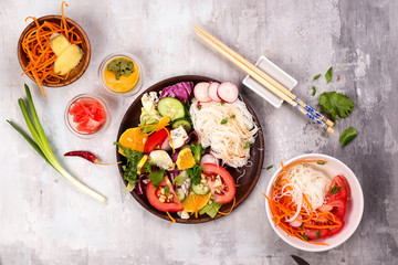 Spicy glass noodles with vegetables - carrots, cucumber, peppers, garlic.