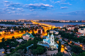 Fototapeta na wymiar Night summer Voronezh. View to the road to Chernavsky Bridge, river and Tikhvin-Onufrievsky church