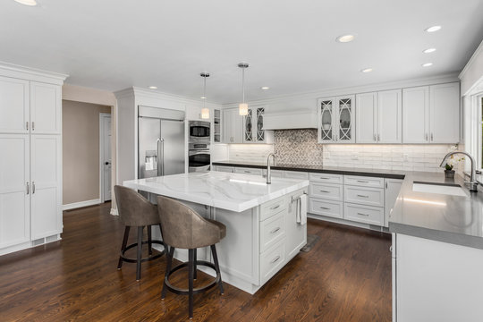 Beautiful Kitchen in New Luxury Home with Island, Oven, Range, Stainless Steel Appliances, and Refrigerator