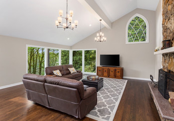 Beautiful living room with vaulted ceilings and hardwood floors in new luxury home