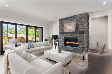 Beautiful Living Room Interior in New Home with Fireplace and Hardwood Floors