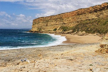 Crystal clear and wild waters in Praia da Foz, Sesimbra, Portugal