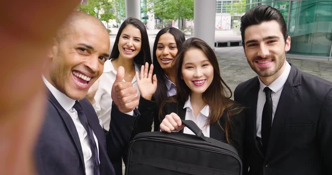 Business people of different ethnic backgrounds dressed in suits and suits, they take a picture in which they smile and they are all happy. Concept of: internationality and technology, social networks
