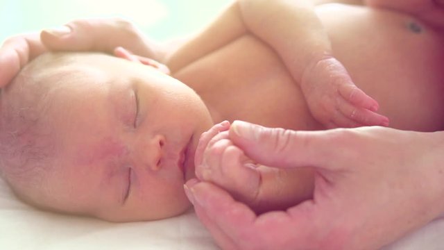Happy mother and her sleeping newborn baby. Maternity concept. Slow motion. 3840X2160 4K UHD video footage