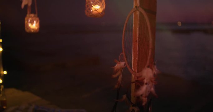 Summer island outdoors decoration with candles and dream catcher