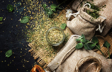 Dried ground oregano or marjoram, dark background, top view