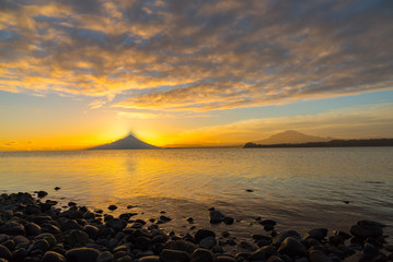 Landscape at sunrise on Lake Llanquihue with Osorno volcano and Calbuco in the background, southern Chile