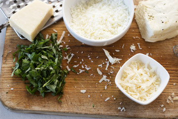 Frittata ingredients: Whisked eggs & milk, halloumi and parmesan cheese, cut basil