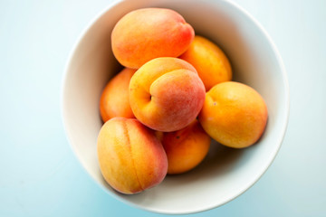 Fresh apricots on blue background