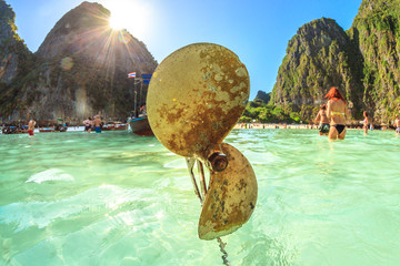 Obraz premium Closeup of propeller of a traditional longtail boat in Maya Bay lagoon, Phi Phi island, Andaman Sea, Thailand. Mass tourism has damaged and polluted the paradisiac island of Ko Phi Phi Leh.