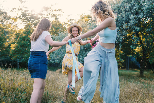 Group of girls friends making picnic outdoor. They dance roundelay with each other. bachelorette, party