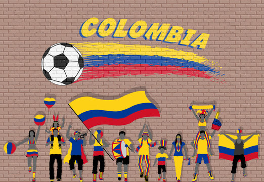 Colombian football fans cheering with Colombia flag colors in front of soccer ball graffiti