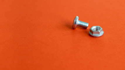 Bolt and nut on the red background. 
