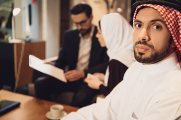 Discouraged Arab man with wife at psychologist