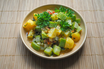 Vegetables stewed with sesame seeds on a bamboo napkin. Asian cuisine.