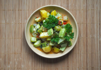 Vegetables stewed with sesame seeds on a bamboo napkin. Asian cuisine.
