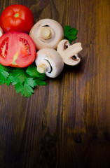 mushrooms mushrooms with parsley and tomatoes on wooden background