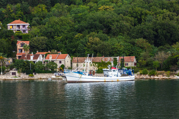 Fototapeta na wymiar Old Boat Docked on Coast of Montenegro