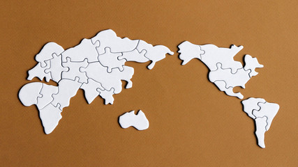 A world map puzzle with a brown background