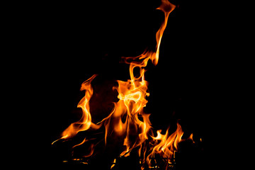 Flames in the fire of a red and yellow barbecue.