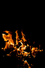 Flames in the fire of a red and yellow barbecue.