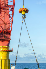 Fototapeta premium Offshore crane on a construction barge performing lifting activities