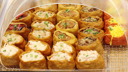 The variety of fried tofu sushi on display at the market.