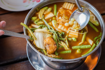 red curry Giant catfish eggs with vegetable in sour soup.
