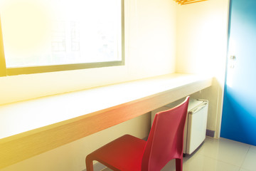  interior room with wooden tables and red chair