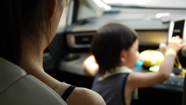 mother and child sitting in car driving road trip