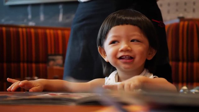 cute child happy eating time in restaurant