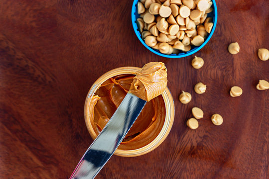 Peanut butter concept healthy nutritious breakfast. Top view. Wooden plate background.