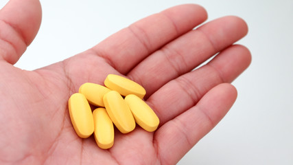 The six yellow pills on the palm of your hand.