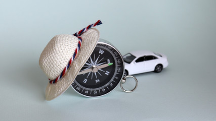 The compass that the white straw hat is wearing and a white miniature car.