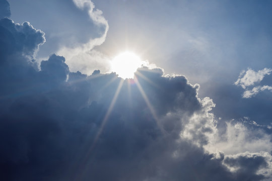 Big White Cloud And Light Ray Behind Cloud With Blue Sky