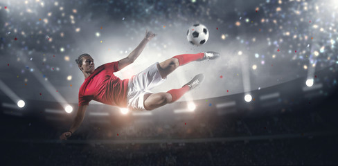 Fototapeta na wymiar Soccer player in action on stadium background.