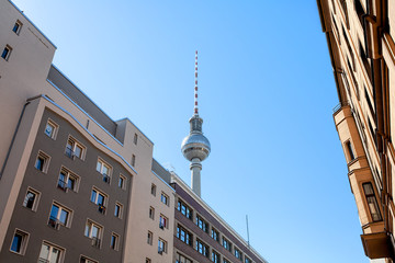 Berlin Television Tower, perspective from a downtown street, with historic buildings, on a clear,...