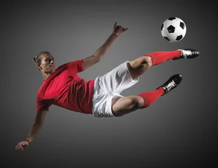 Deurstickers Soccer player in action on black background. © efks