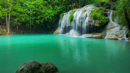 Breathtaking green waterfall at tropical rain forest, Erawan waterfall located Kanchanaburi Province, Thailand