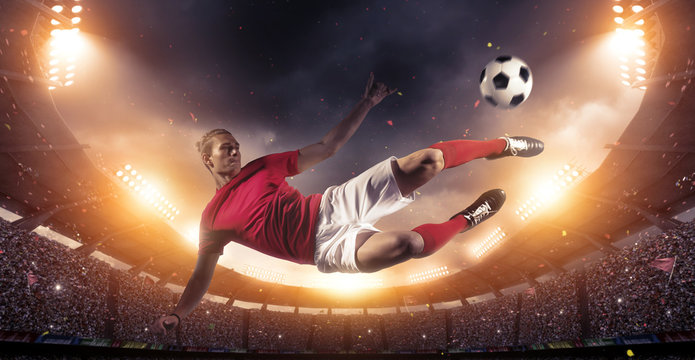 Fototapeta Soccer player in action on stadium background.