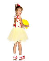 Little girl is playing with a ball