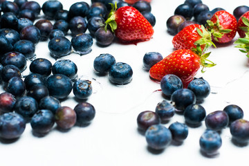 isolated strawberries and blueberries on a white background