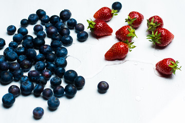 isolated strawberries and blueberries on a white background