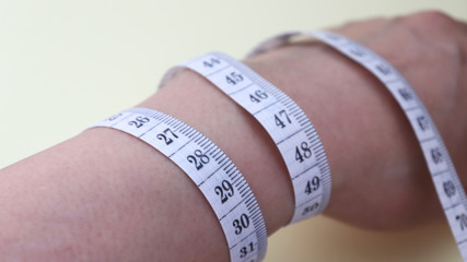 A tape measure around one's wrist.