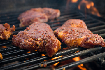 grilled pork with flames on barbecue