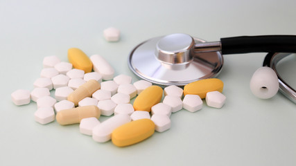 Close-up image of stethoscope and pills.