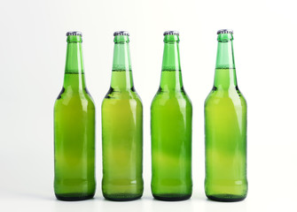 Four bottles of beer isolated on white background