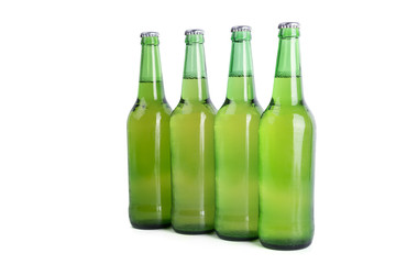 Four bottles of beer isolated on white background