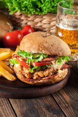 Chickenburger with bacon, tomato, cheese and lettuce