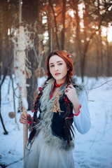  Beautiful girl with long braids in a winter forest. A witch from a fairy tale. fantasy Photo